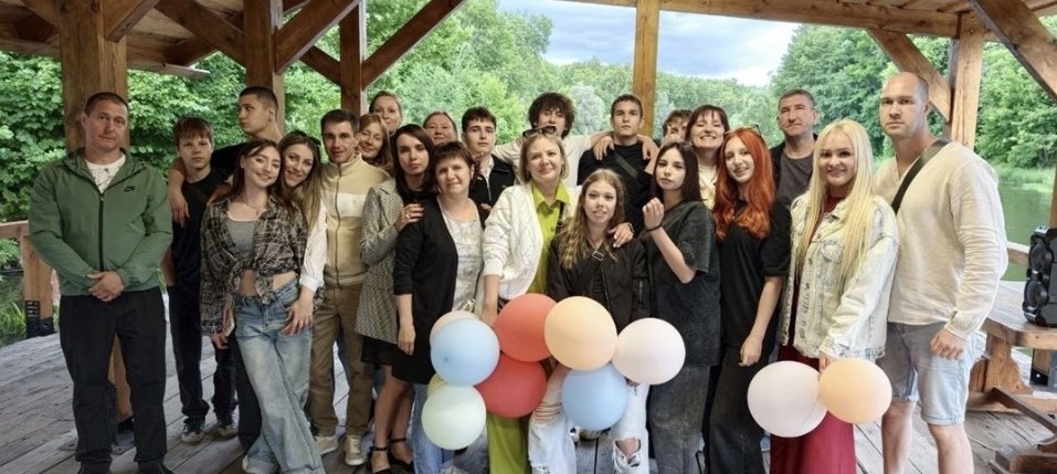 Общее фото выпускников и родителей с воздушными шарами в беседке на природе